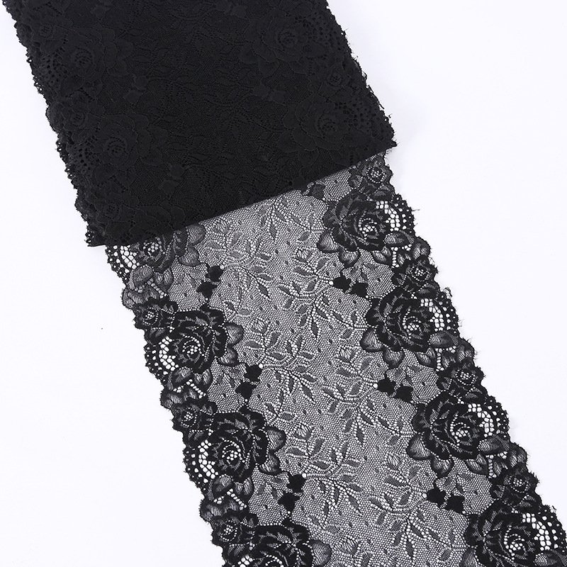 Close-up shot of black elastic lace floral embroidery, showcasing elegant texture