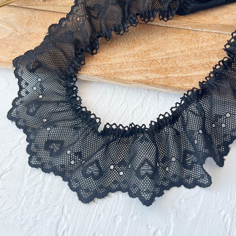 Black ruffled lace trim for a sophisticated and timeless touch to your fashion projects