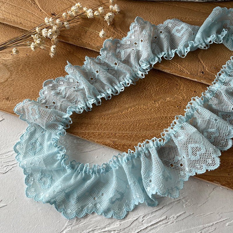 Soft blue ruffled lace edge, perfect for adding a delicate touch to garments and crafts