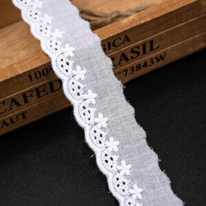 Beautiful white cotton lace trim in a unique scalloped fan shape, great for adding texture to fashion projects