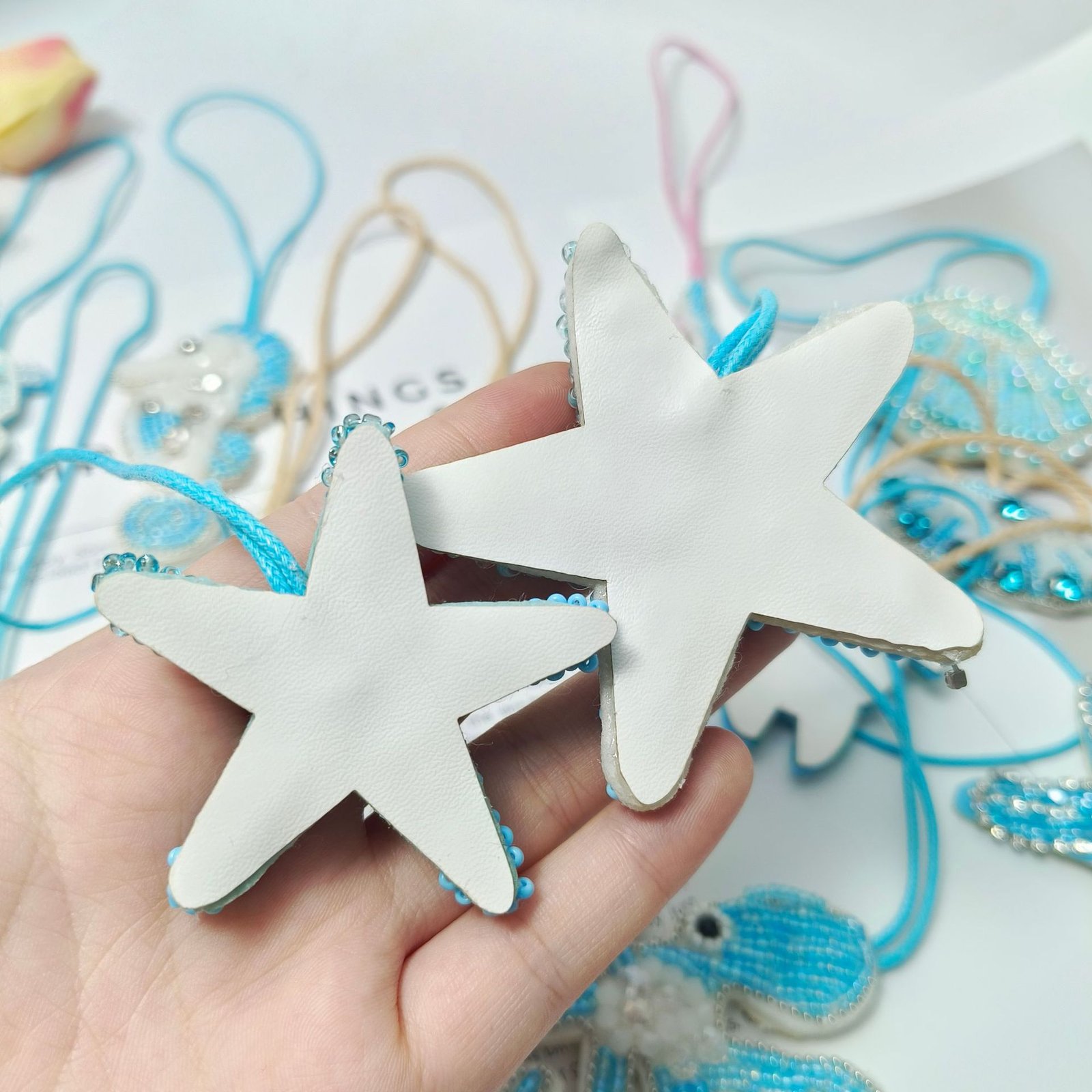 Backside view of white starfish embroidery pendant handmade applique DIY lace accessory
