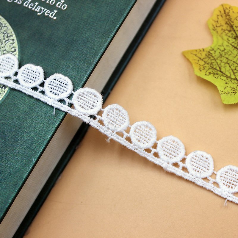 Detailed view of soft white water-soluble lace, perfect for embellishing wedding dresses and accessories