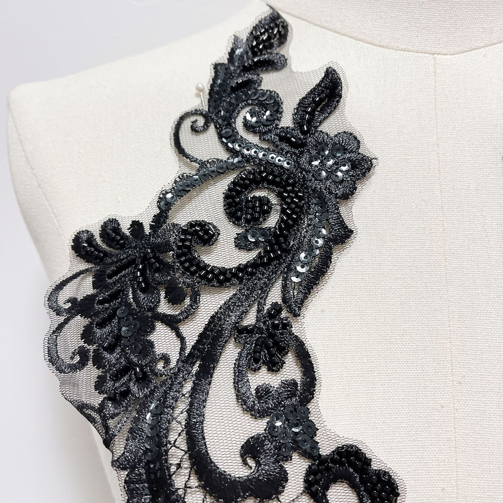 Close-up of black lace embroidery applique neckline decoration for clothing design