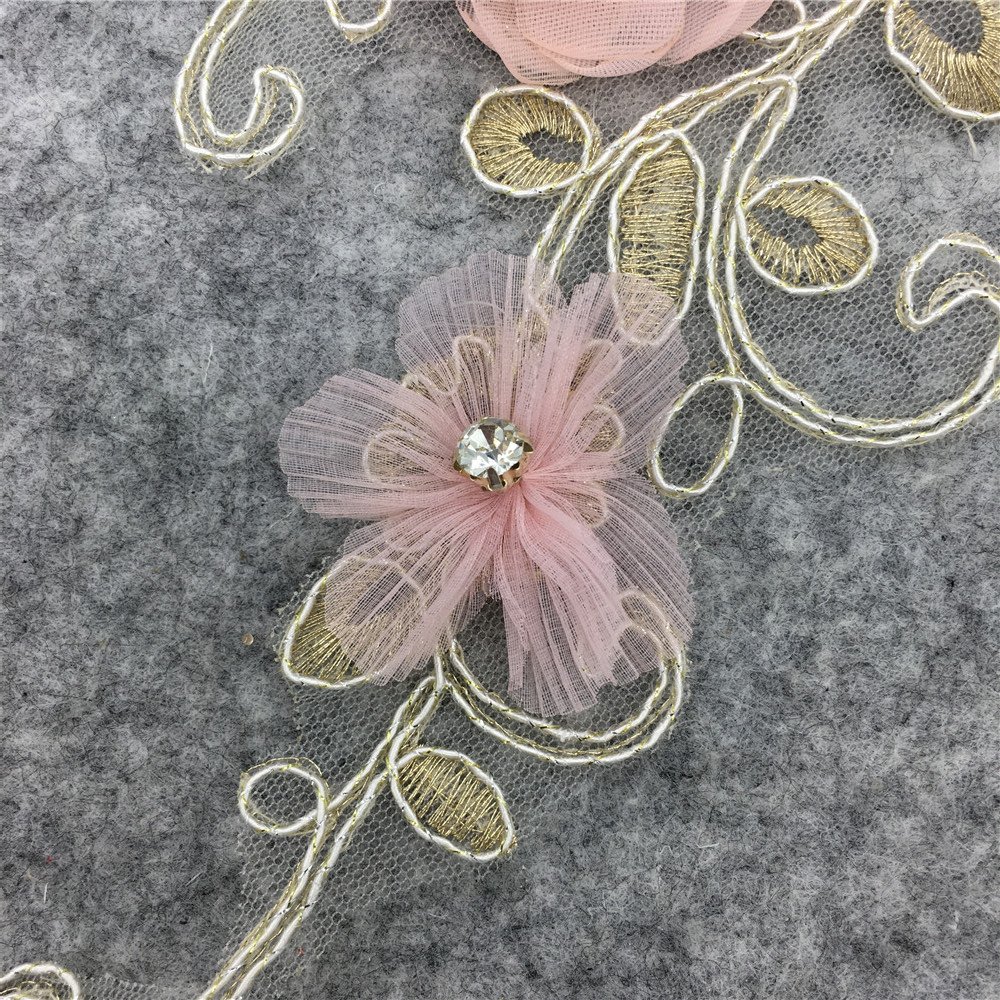 Close-up of 3D embroidery applique pink flower with rhinestone center for DIY fashion design