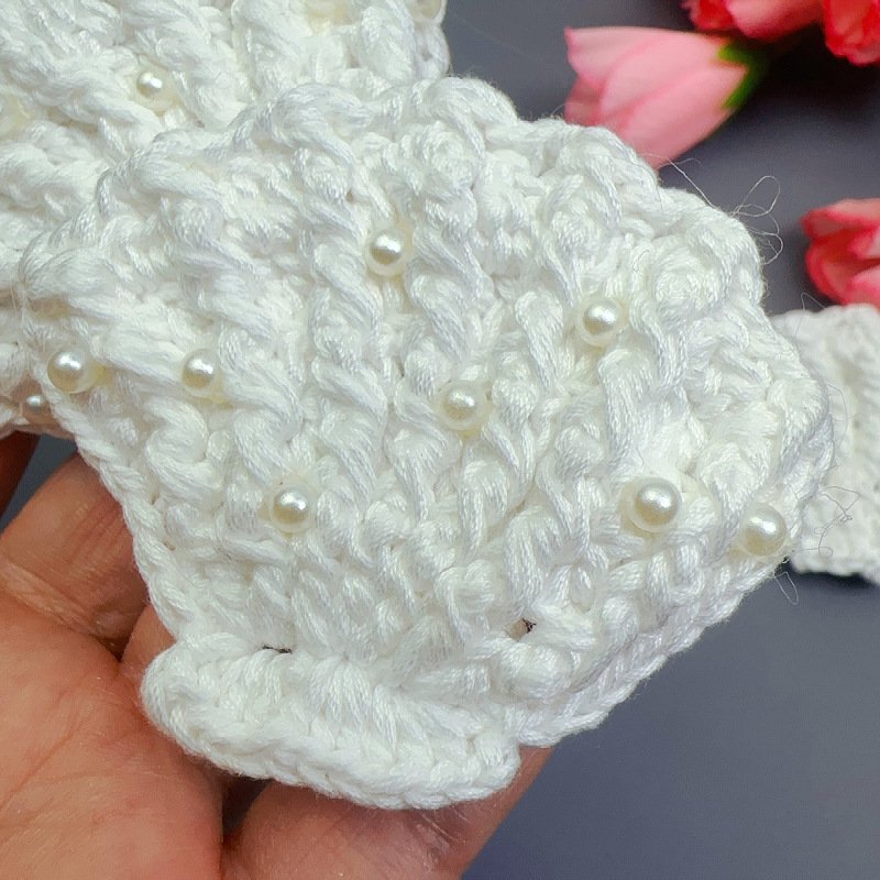 Close-up of cotton thread crochet seashell appliqué patch with pearls for crafts