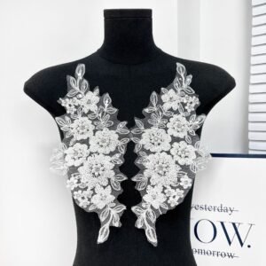White 3D floral embroidery appliqué arranged symmetrically on dress form